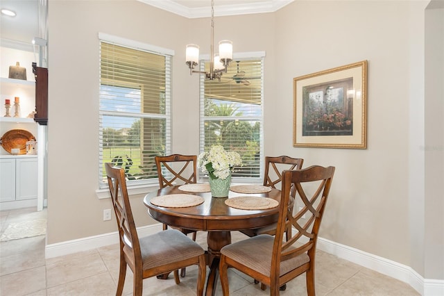 tiled dining space featuring crown molding and an inviting chandelier