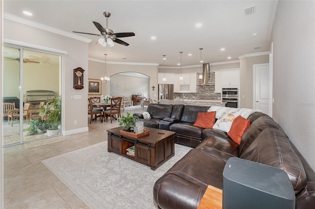 living room featuring ornamental molding, light tile patterned floors, and ceiling fan with notable chandelier