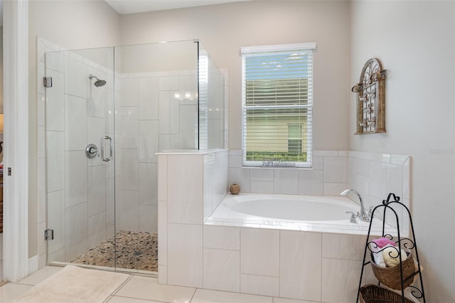 bathroom featuring tile patterned flooring and shower with separate bathtub