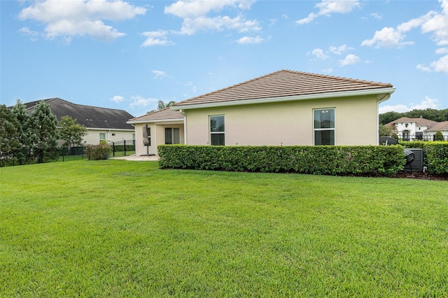 rear view of property with a yard and a patio