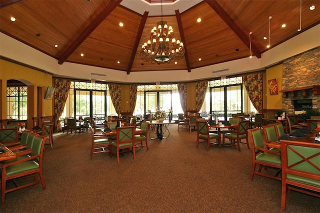 dining room featuring high vaulted ceiling, a fireplace, wooden ceiling, and an inviting chandelier