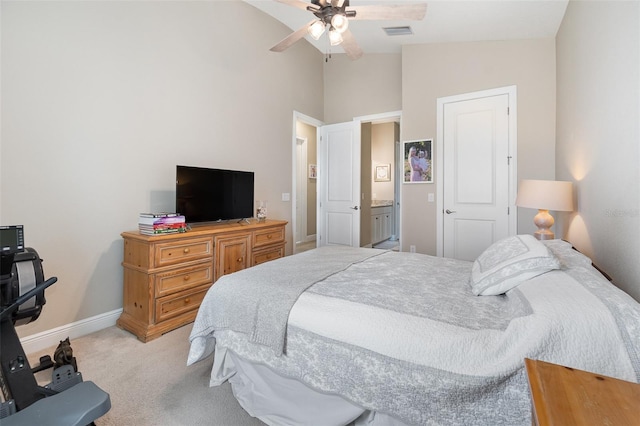 carpeted bedroom with ceiling fan, vaulted ceiling, and connected bathroom