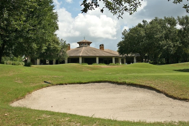 view of property's community with a lawn