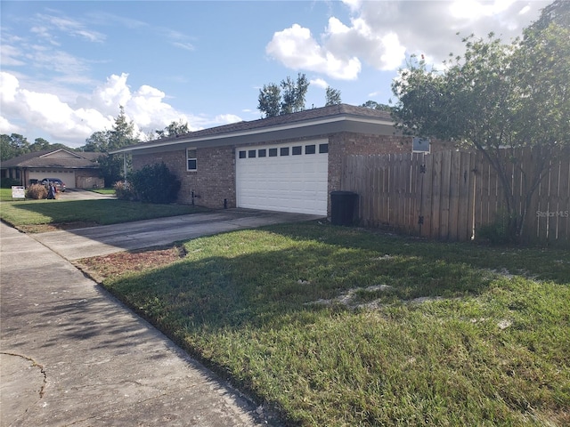 view of front of property with a garage and a front lawn