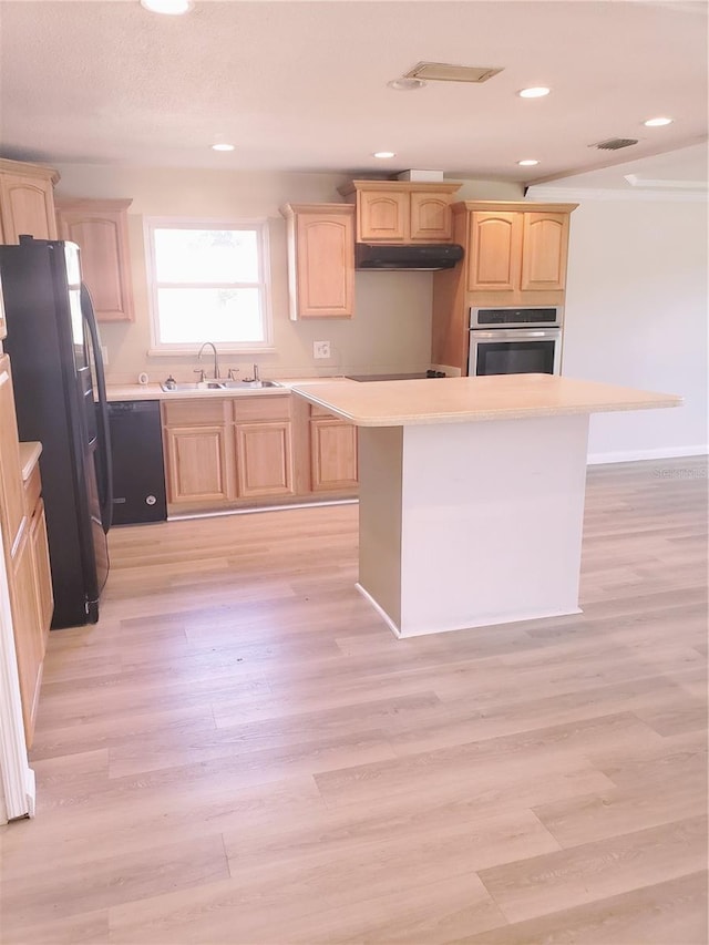 kitchen with light hardwood / wood-style flooring, black appliances, a kitchen island, and sink