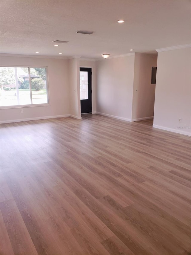 unfurnished room with hardwood / wood-style flooring and crown molding