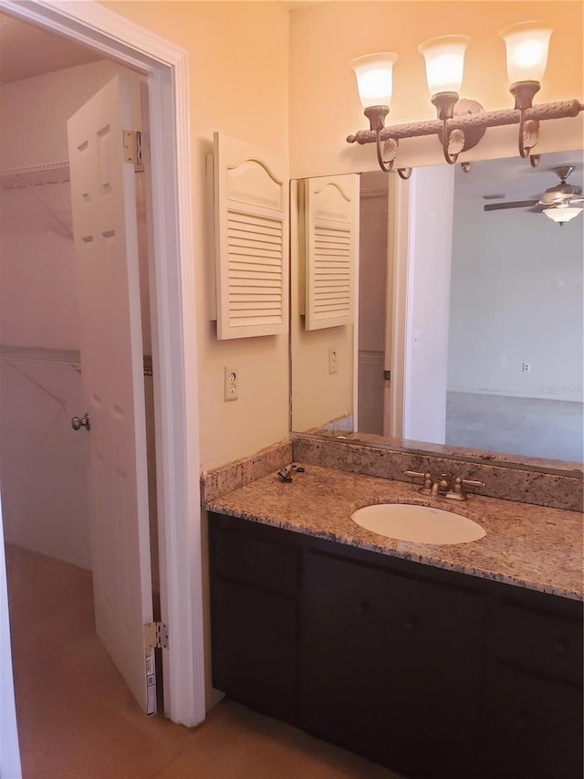 bathroom featuring ceiling fan and vanity