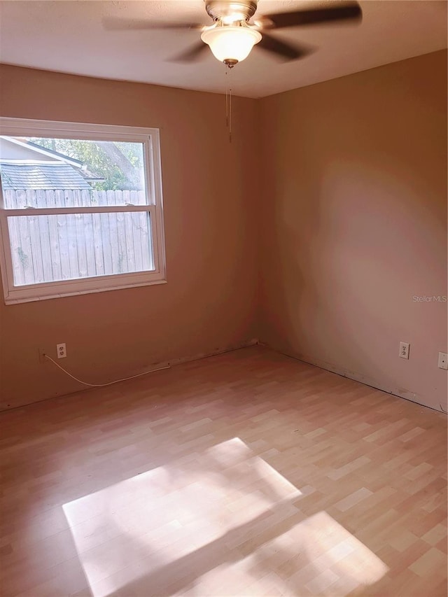 spare room featuring ceiling fan and light hardwood / wood-style floors