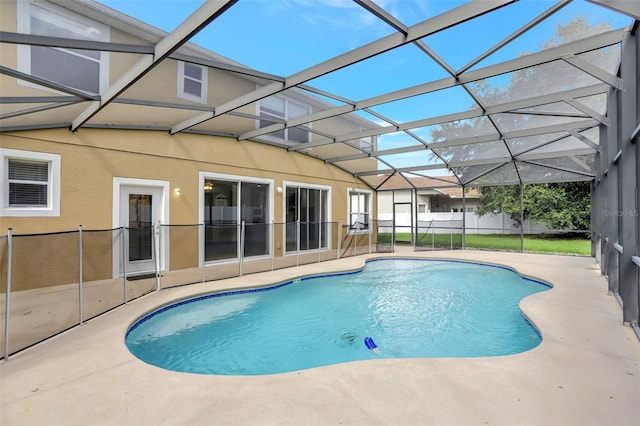 view of pool featuring glass enclosure and a patio area