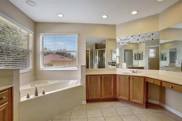 bathroom with independent shower and bath, vanity, tile patterned flooring, and a textured ceiling