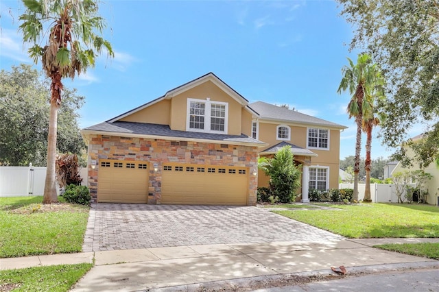 view of front of home with a front yard and a garage