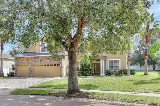 view of property hidden behind natural elements with a front lawn