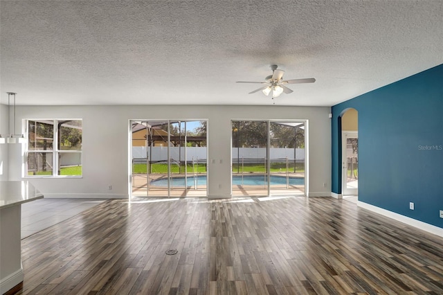 spare room featuring ceiling fan, a textured ceiling, and hardwood / wood-style floors