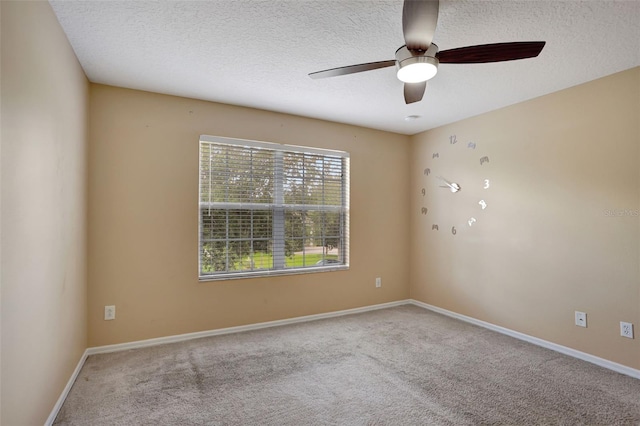 unfurnished room featuring ceiling fan, carpet floors, and a textured ceiling