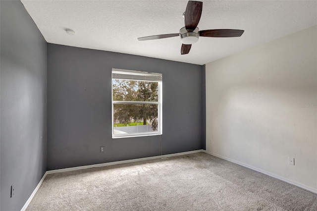 spare room with ceiling fan, carpet floors, and a textured ceiling