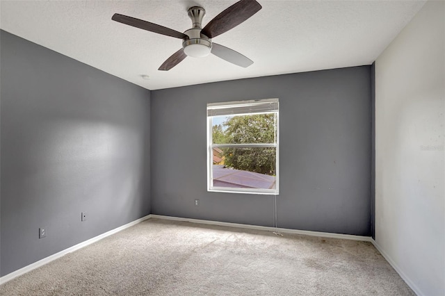 empty room with carpet, a textured ceiling, and ceiling fan