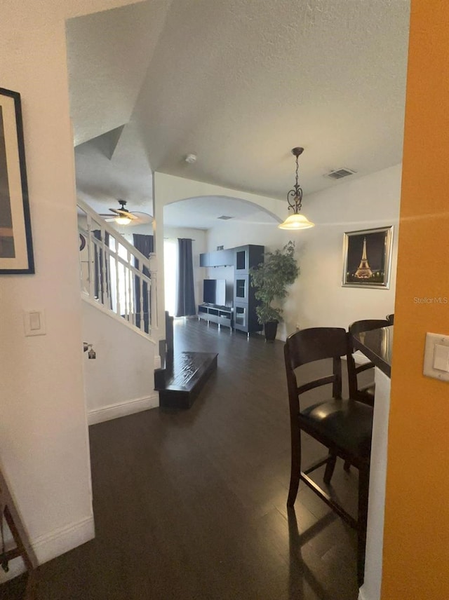 dining space with ceiling fan and a textured ceiling