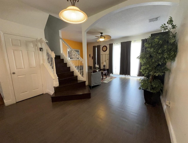 entrance foyer with a textured ceiling, dark hardwood / wood-style flooring, and ceiling fan