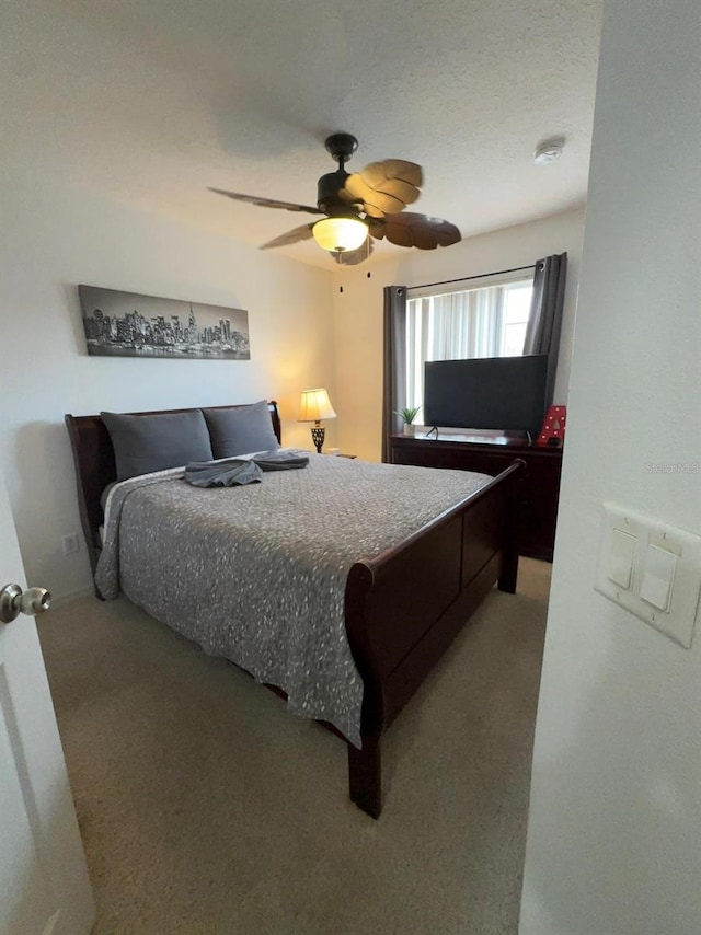 bedroom with ceiling fan and carpet floors