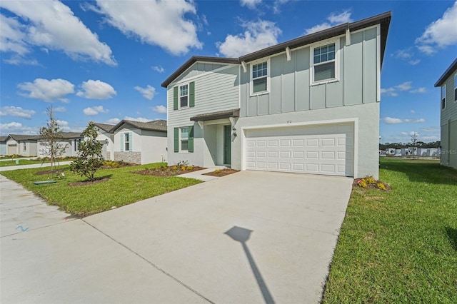 view of front of property featuring a garage and a front yard