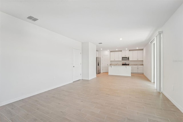 unfurnished living room with light hardwood / wood-style floors