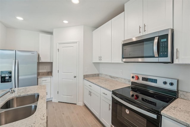 kitchen featuring white cabinetry, appliances with stainless steel finishes, and light hardwood / wood-style floors