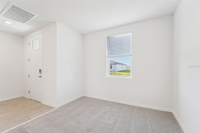 spare room with light hardwood / wood-style flooring