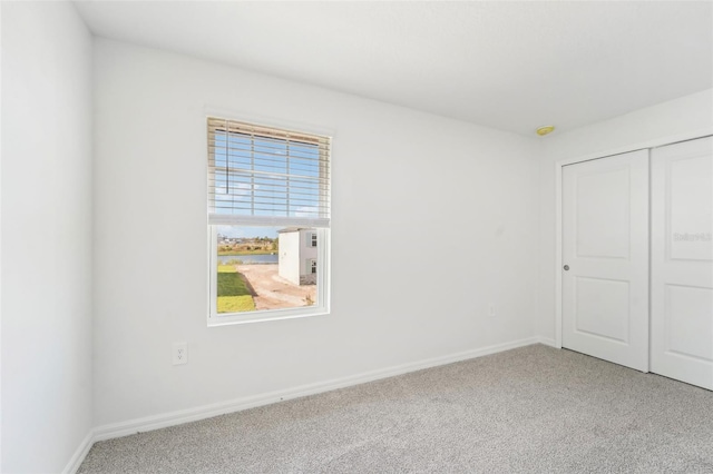 unfurnished bedroom featuring a closet and carpet floors