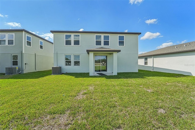 back of house with a lawn and central AC