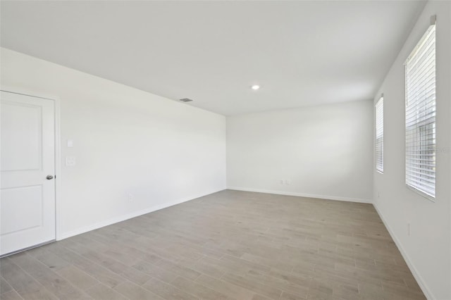 spare room featuring light hardwood / wood-style flooring