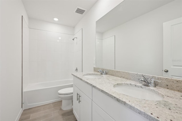 full bathroom featuring vanity, shower / bath combination, and toilet