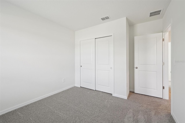 unfurnished bedroom featuring a closet and carpet floors