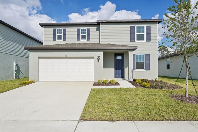 front of property featuring a front lawn and a garage