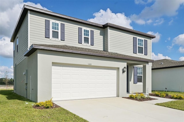 view of property featuring a garage and a front lawn