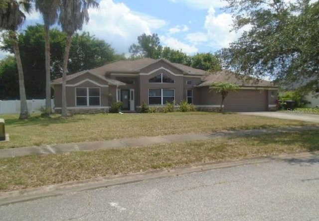 ranch-style house with a front lawn and a garage