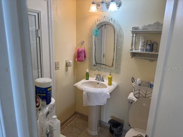 bathroom with tile patterned floors and toilet