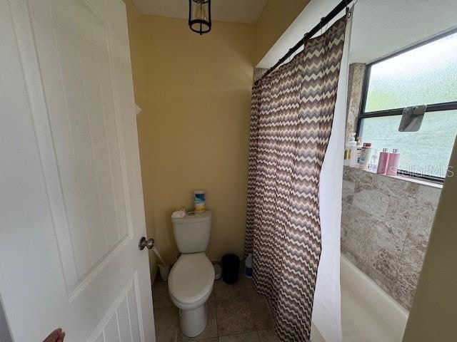 bathroom featuring tile patterned flooring and toilet