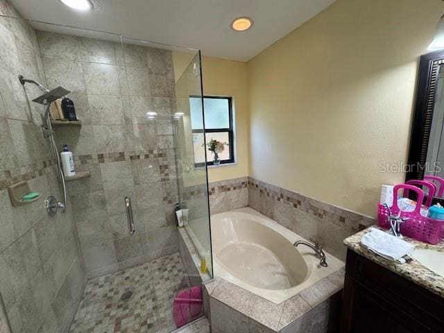 bathroom featuring vanity and plus walk in shower