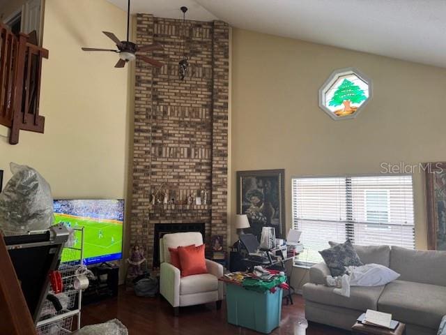 living room with ceiling fan, dark hardwood / wood-style flooring, lofted ceiling, and a fireplace