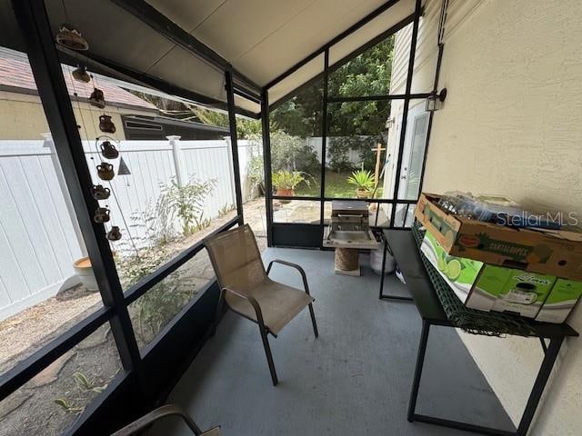 sunroom / solarium featuring vaulted ceiling