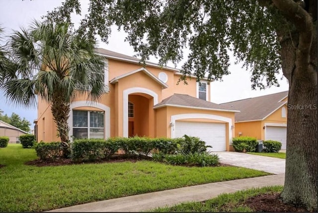 view of front of home featuring a front yard and a garage