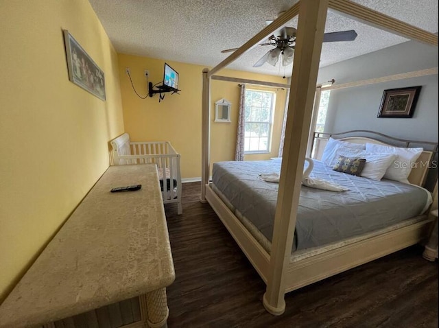 bedroom with ceiling fan, dark wood-type flooring, and a textured ceiling