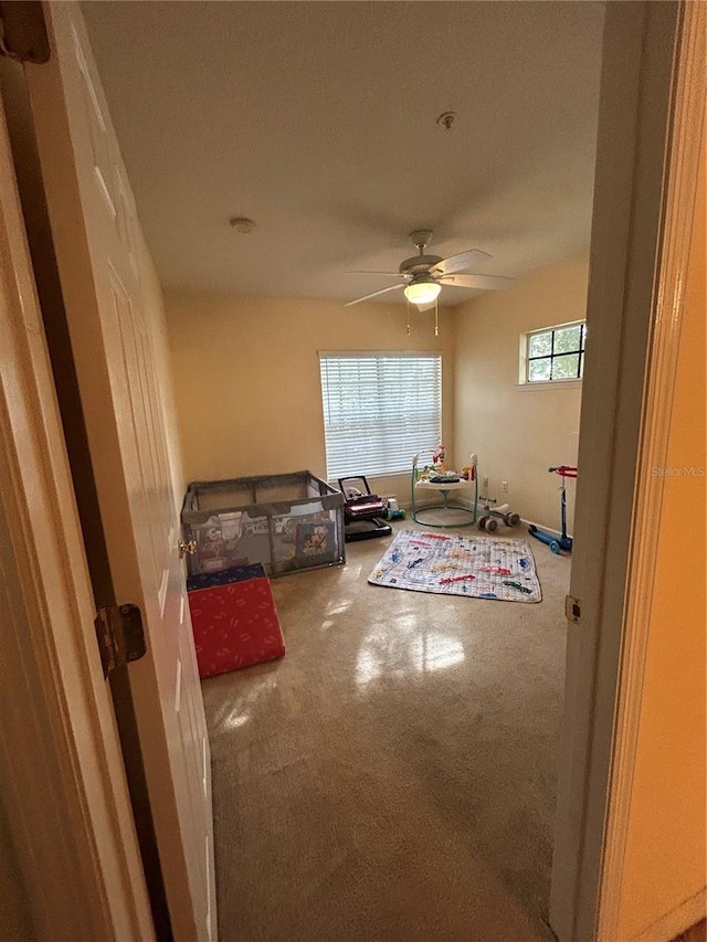 interior space with ceiling fan