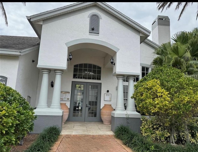 entrance to property featuring french doors and covered porch