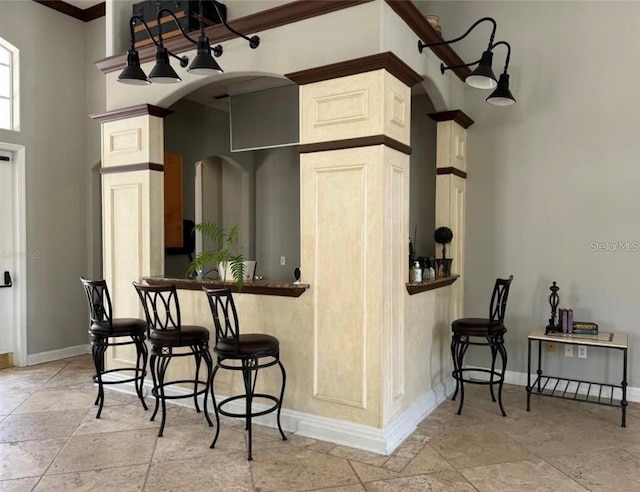 kitchen featuring ornamental molding and a kitchen breakfast bar