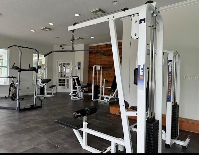 workout area with a textured ceiling and ornamental molding