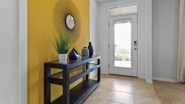 doorway to outside featuring light tile patterned flooring