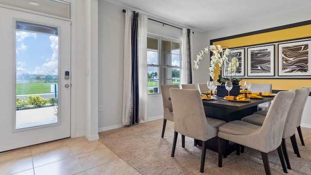 dining area featuring light tile patterned flooring