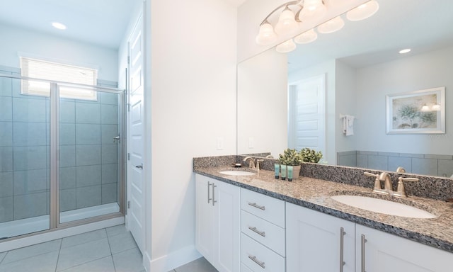 bathroom with vanity, tile patterned floors, and a shower with shower door