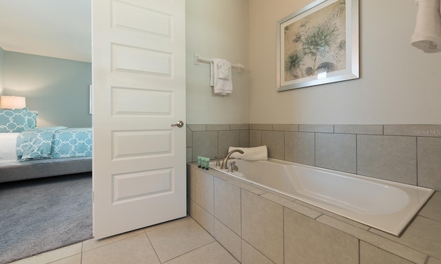 bathroom with tiled bath and tile patterned floors